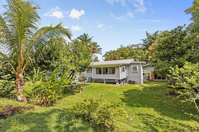 rear view of house with a yard