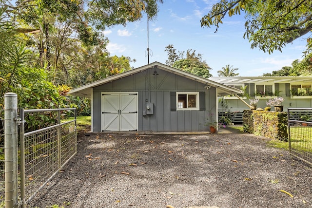 view of outbuilding featuring fence