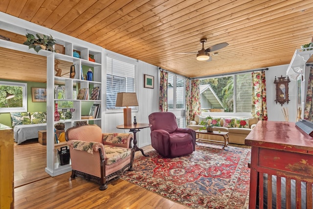 interior space with a ceiling fan, wood finished floors, wood ceiling, and a healthy amount of sunlight