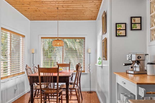 dining area featuring wooden ceiling, wood finished floors, baseboards, and lofted ceiling