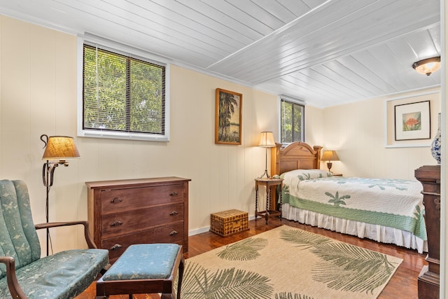 bedroom with wooden ceiling and wood finished floors