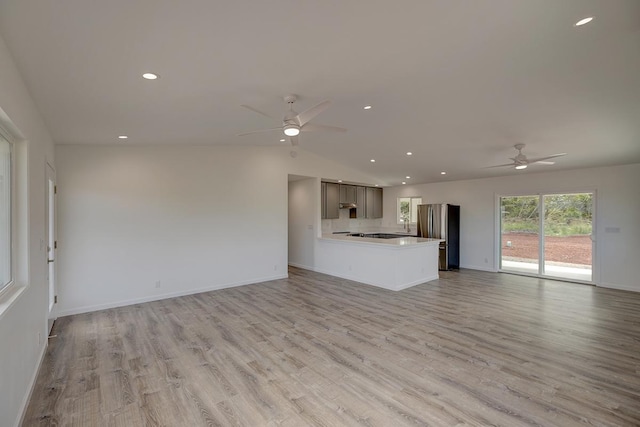 unfurnished living room featuring ceiling fan, baseboards, lofted ceiling, recessed lighting, and light wood-style floors