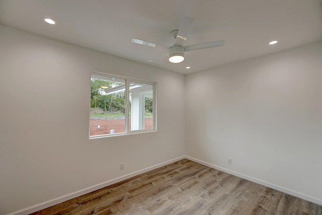 spare room featuring recessed lighting, baseboards, and light wood-type flooring