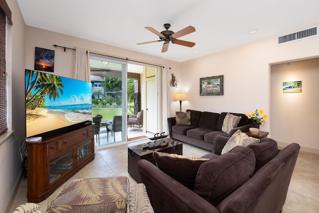 living area with visible vents, baseboards, ceiling fan, and light tile patterned flooring