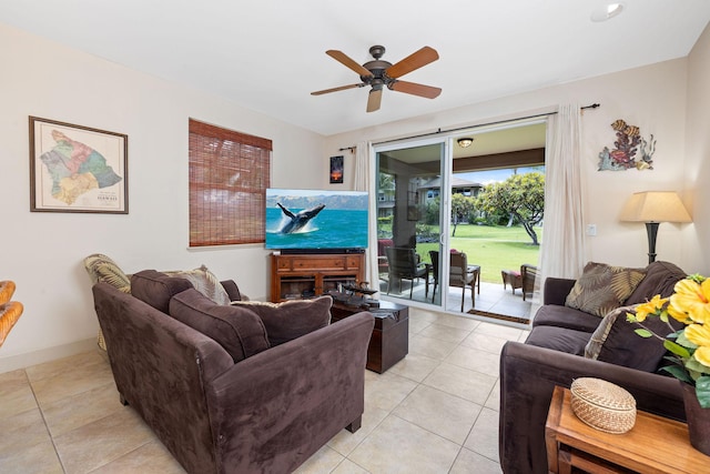 living area with light tile patterned floors, baseboards, and a ceiling fan