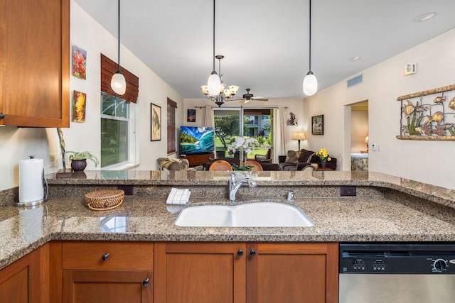 kitchen featuring visible vents, a chandelier, open floor plan, stainless steel dishwasher, and a sink