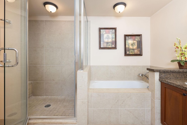 bathroom with vanity, a bath, and a stall shower