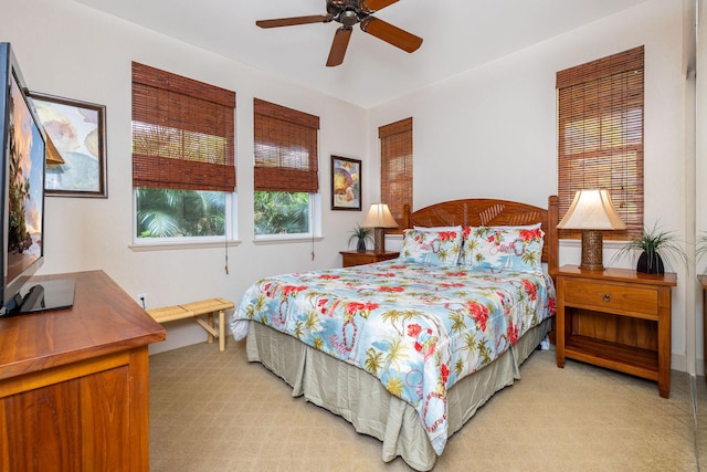 bedroom featuring light colored carpet and a ceiling fan