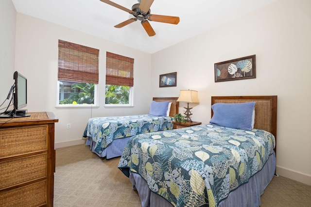 carpeted bedroom featuring baseboards and ceiling fan