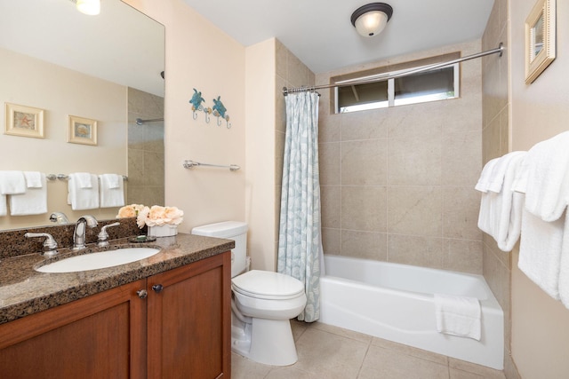 bathroom featuring tile patterned floors, vanity, toilet, and shower / bath combo with shower curtain