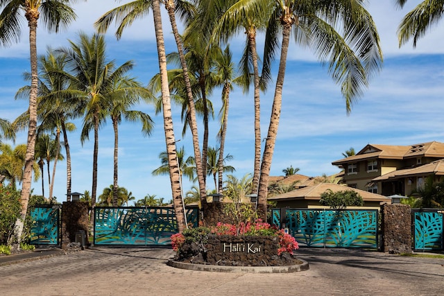 exterior space with a gated entry, curbs, and a gate