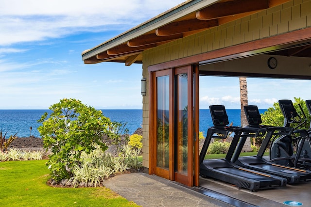 exterior space featuring stone finish floor, plenty of natural light, and a water view