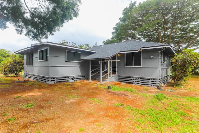 view of front facade featuring roof with shingles