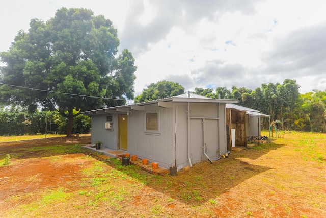 view of home's exterior with a wall mounted air conditioner