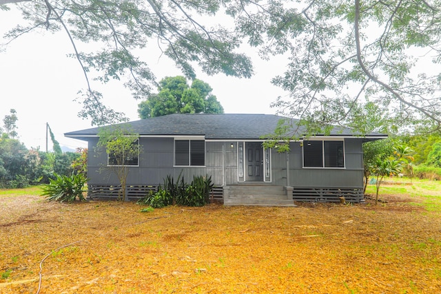 view of front of home with entry steps and roof with shingles