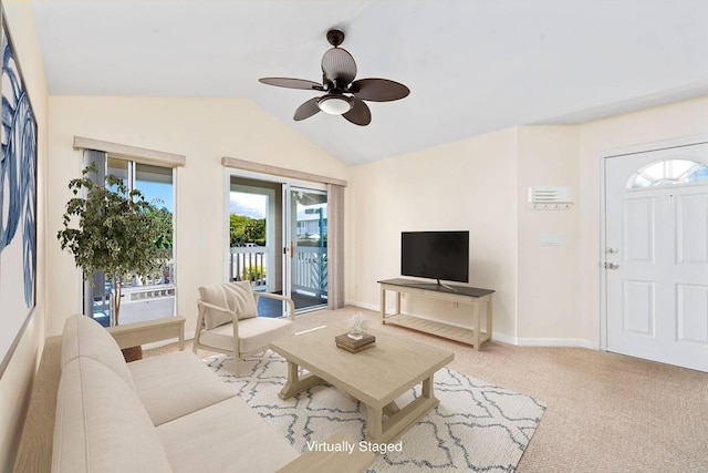 living room with carpet flooring, baseboards, ceiling fan, and vaulted ceiling