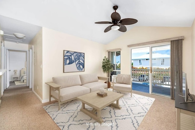 carpeted living area with ceiling fan, baseboards, and vaulted ceiling