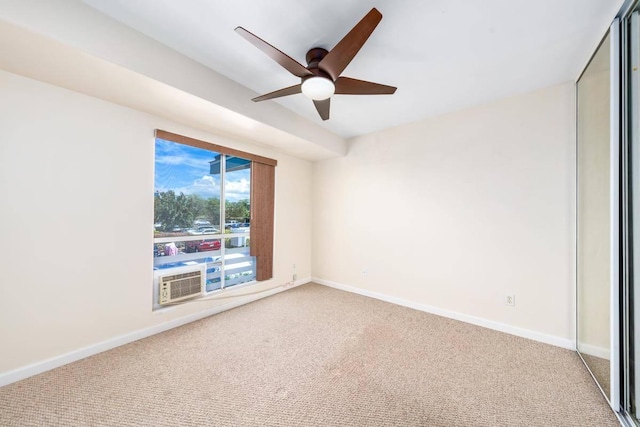 carpeted empty room featuring cooling unit, baseboards, and a ceiling fan