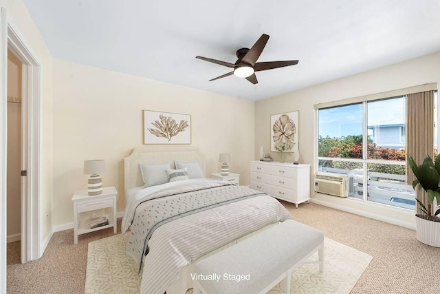 bedroom with light carpet, cooling unit, a ceiling fan, and baseboards