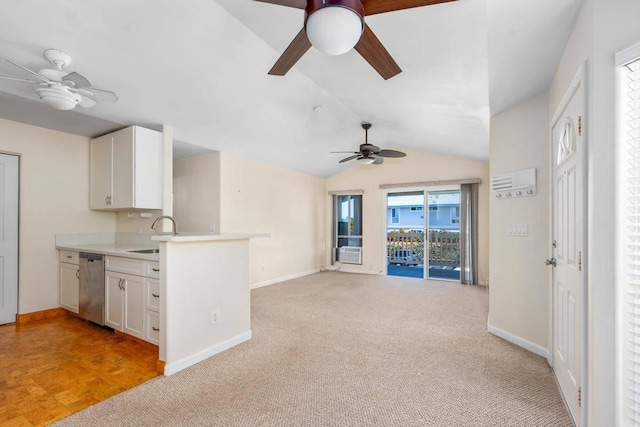 kitchen with a sink, dishwasher, open floor plan, and white cabinets