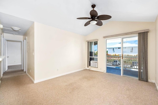 empty room featuring carpet flooring, ceiling fan, baseboards, and lofted ceiling