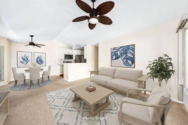 carpeted living area featuring baseboards, a ceiling fan, and lofted ceiling