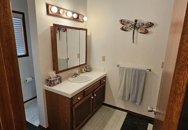 bathroom with vanity and baseboards