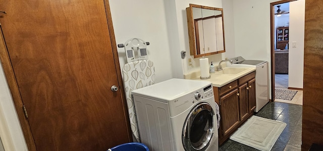 laundry area featuring cabinet space, independent washer and dryer, and a sink