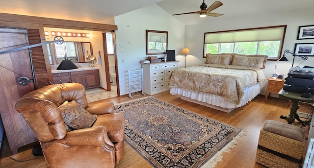 bedroom featuring light wood-style flooring, lofted ceiling, and multiple windows