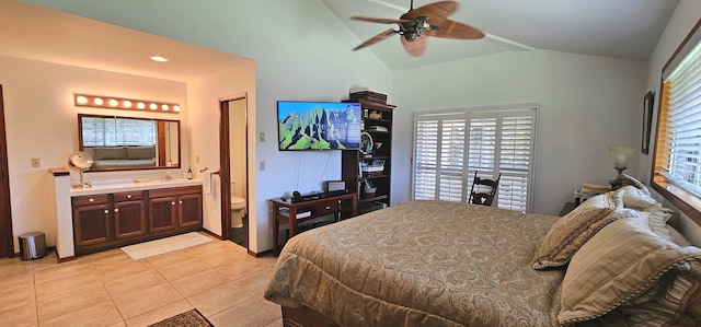 bedroom featuring ceiling fan, vaulted ceiling, light tile patterned floors, recessed lighting, and ensuite bath