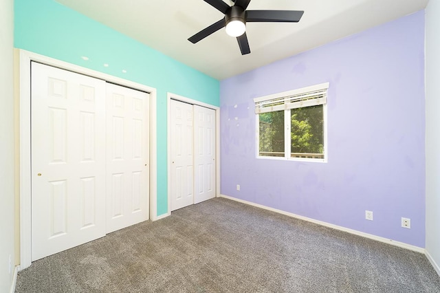 68-3868 Paniolo Ave Unit A201, Waikoloa, HI 96738 - unfurnished bedroom with multiple closets, carpet floors, baseboards, and ceiling fan