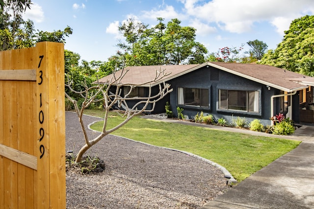 view of front of property with a front yard and stucco siding