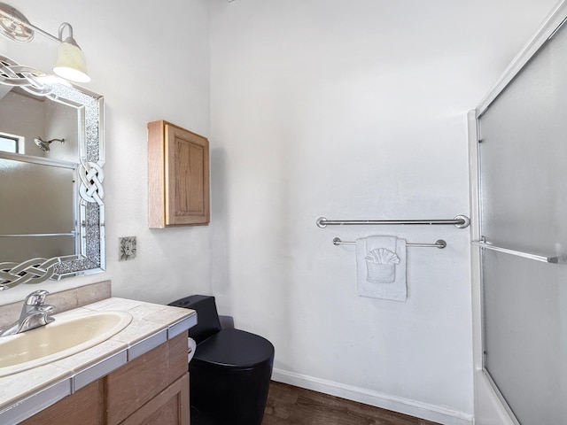 87-2814 Hawaii Belt Rd, Captain Cook, HI 96704 - bathroom featuring toilet, vanity, wood finished floors, bath / shower combo with glass door, and baseboards