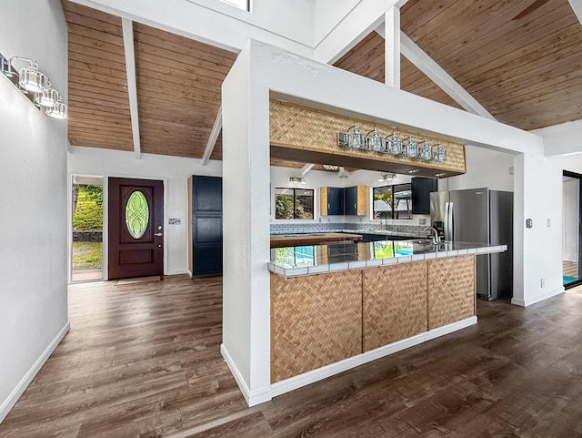 87-2814 Hawaii Belt Rd, Captain Cook, HI 96704 - kitchen with stainless steel fridge, tile countertops, wooden ceiling with exposed beams, dark wood-style flooring, and baseboards