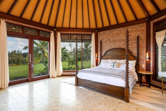 unfurnished bedroom featuring lofted ceiling and access to outside