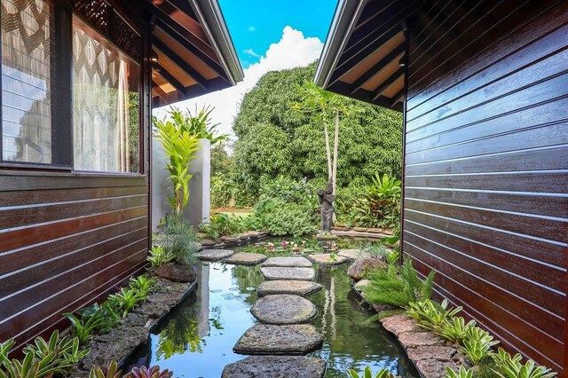 view of yard featuring a garden pond