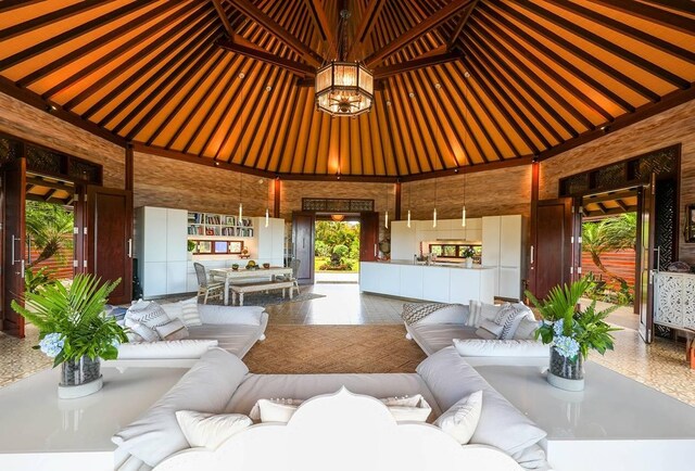 living room featuring a towering ceiling and an inviting chandelier
