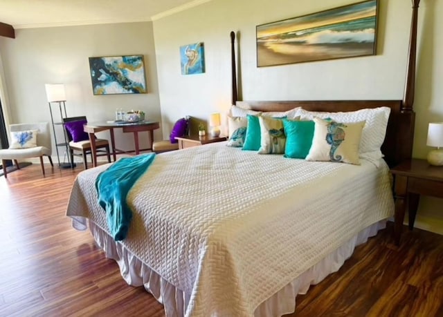 bedroom with ornamental molding and wood finished floors