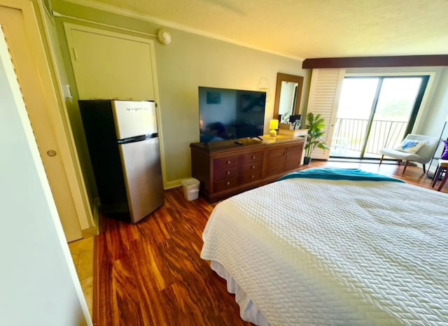 bedroom with baseboards, dark wood finished floors, freestanding refrigerator, ornamental molding, and access to exterior