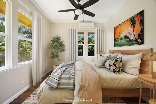 210 Eggerking Rd, Kapaa, HI 96746 - bedroom featuring an AC wall unit, baseboards, wood finished floors, and ceiling fan