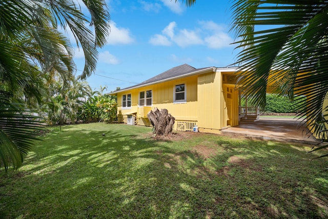 210 Eggerking Rd, Kapaa, HI 96746 - back of house featuring a yard, a patio, and board and batten siding