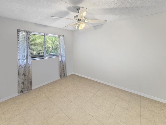 unfurnished room with a textured ceiling, baseboards, and ceiling fan