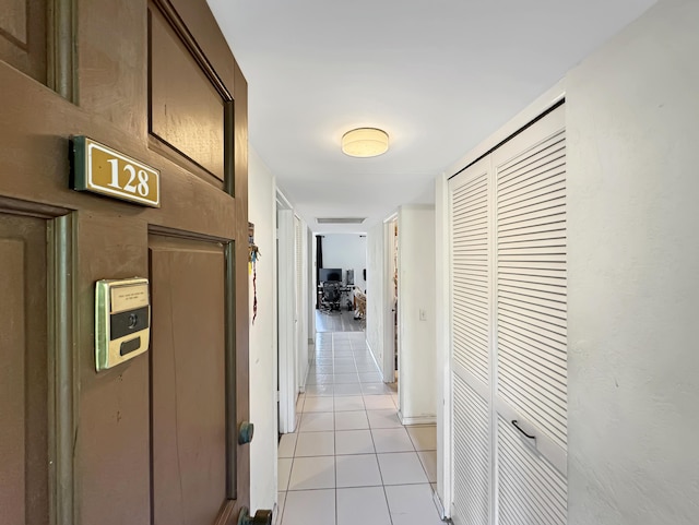hall with light tile patterned floors