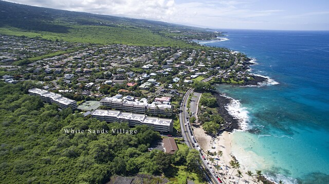 aerial view with a water view and a view of the beach