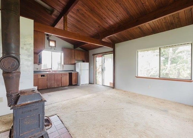 11-3169 Volcano Rd, Volcano, HI 96785 - unfurnished living room with a wealth of natural light, vaulted ceiling with beams, and a wood stove