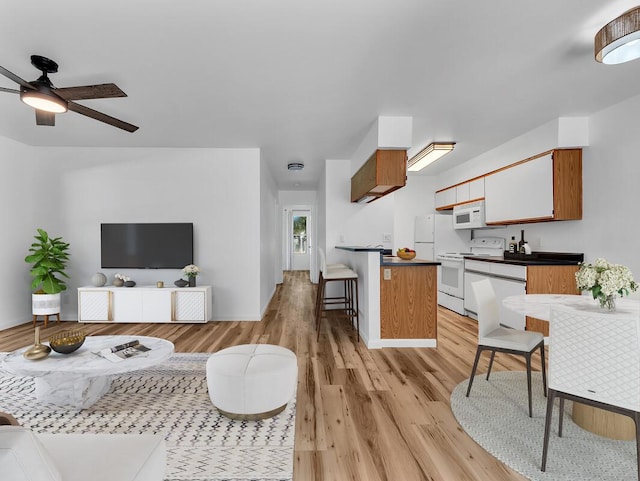 68-3831 Lua Kula St Unit C107, Waikoloa, HI 96738 - living area with a ceiling fan and light wood-style flooring