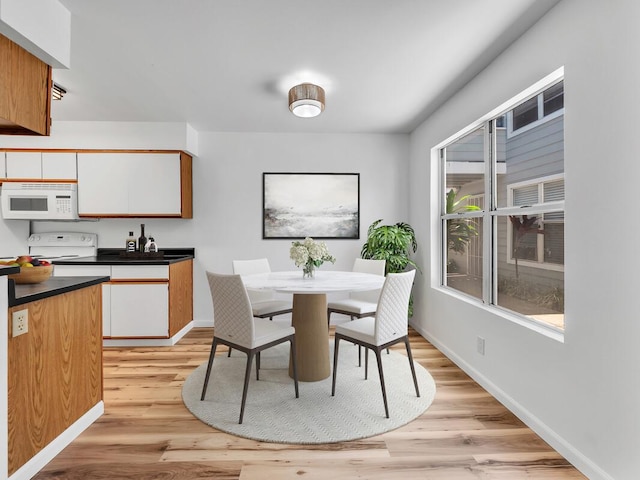 68-3831 Lua Kula St Unit C107, Waikoloa, HI 96738 - dining room featuring baseboards and light wood-style flooring