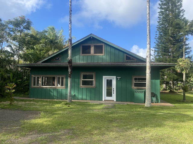 4631 Kahiliholo Rd, Kilauea, HI 96754 - back of house featuring a lawn and board and batten siding