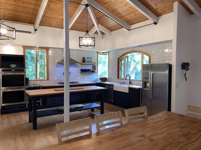 4631 Kahiliholo Rd, Kilauea, HI 96754 - kitchen featuring tasteful backsplash, a chandelier, dark cabinetry, stainless steel appliances, and a sink
