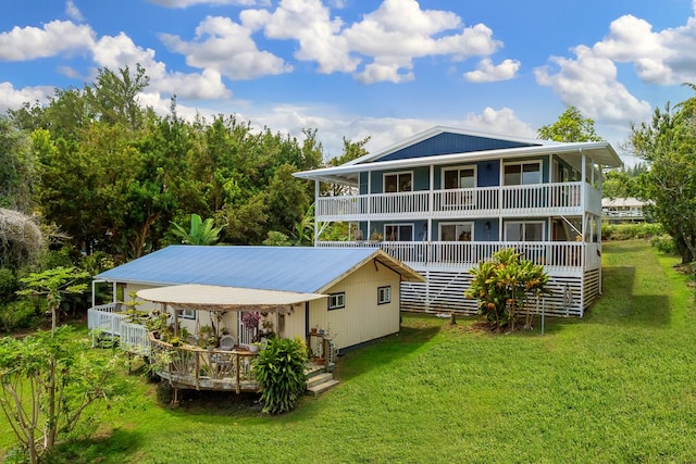 rear view of property featuring a lawn